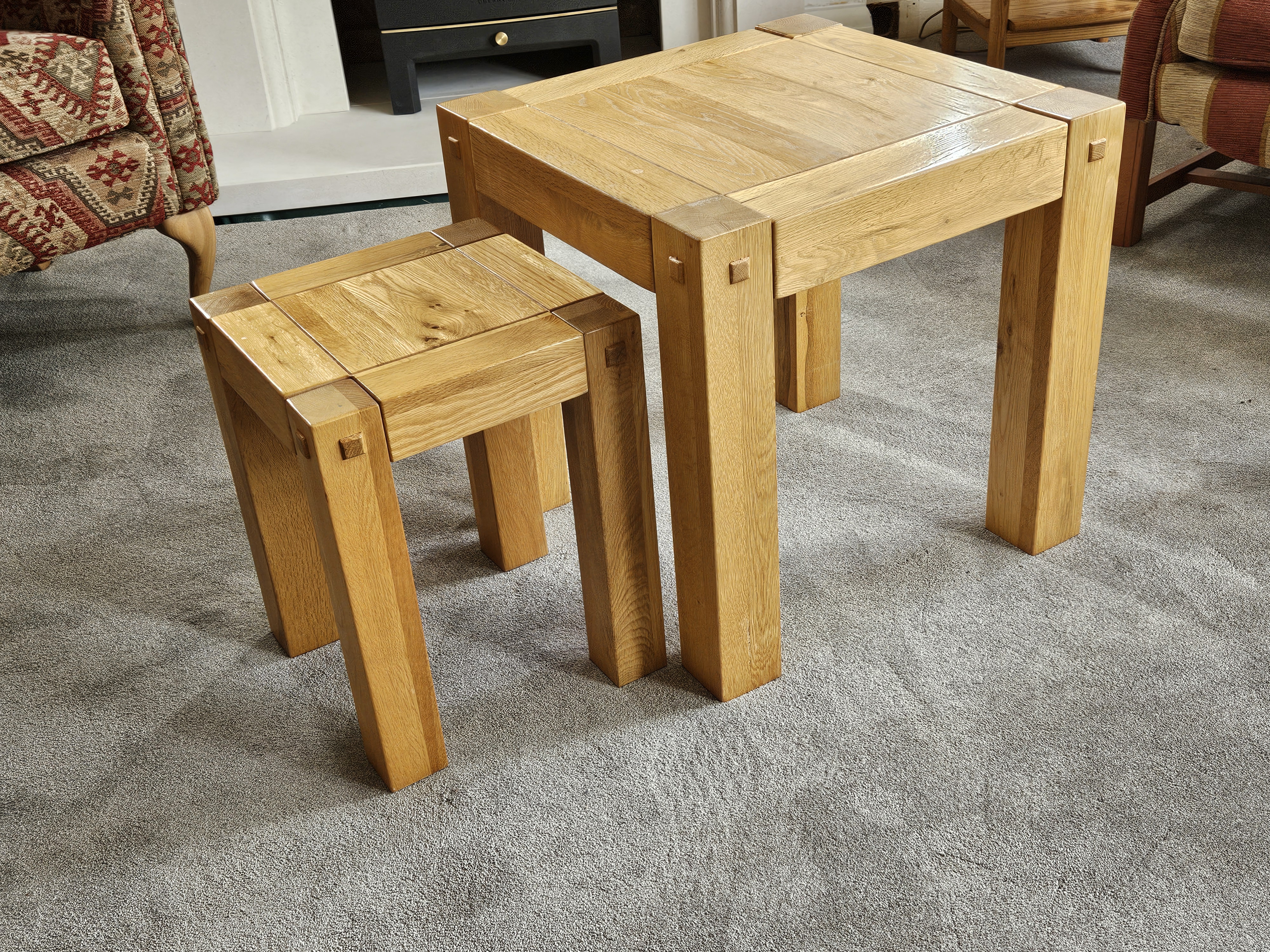 Pair of solid oak coffee tables, one medium sized and  one small.
The small table can nest under the medium table. They are in good condition.
Small table 31cm x 31cm and 40 cm tall.
Medium table 49 cm x 49 cm and 49 cm tall.
Two pairs available
